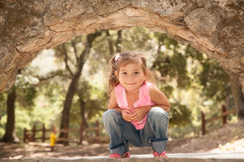 Portrait of a 5 year old crouching under a bridge, Tara Gill Photo